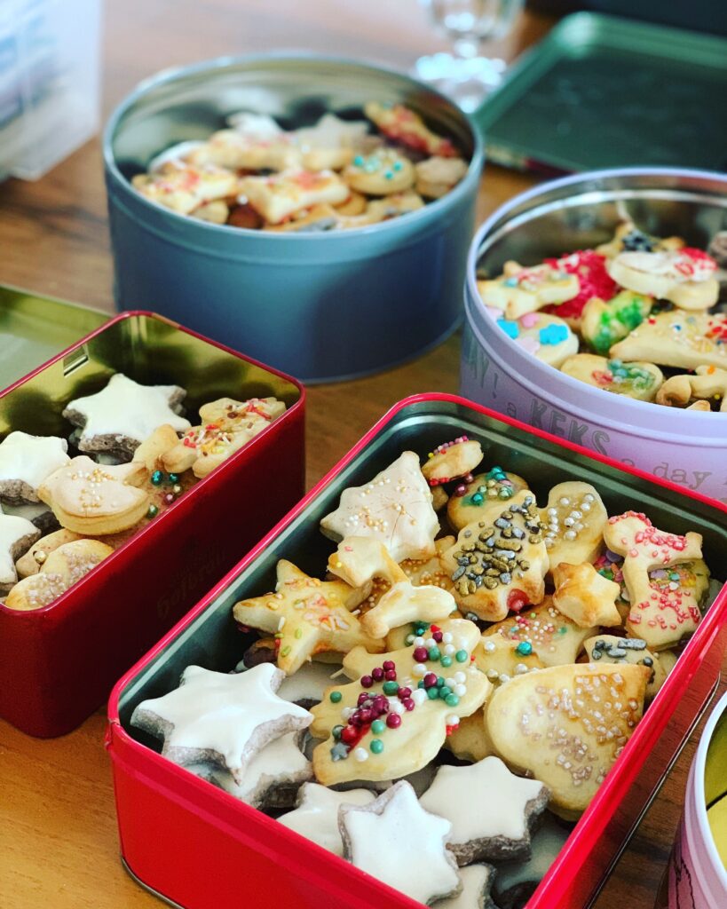 A festive tray of Christmas sugar cookies topped with colorful frosting and holiday sprinkles, perfect for holiday gatherings and celebrations.